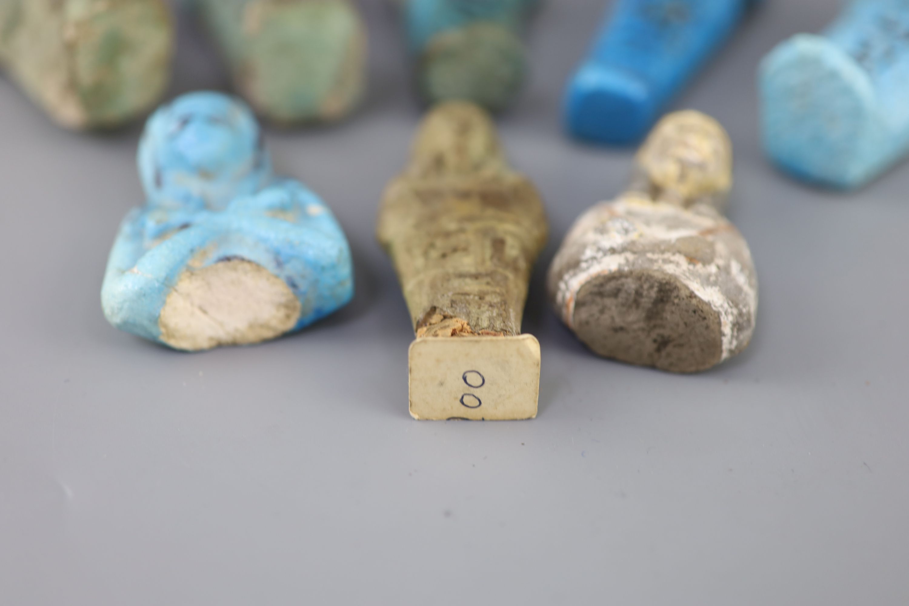 Five Egyptian turquoise glazed faience shabti and three fragments, New Kingdom to late period, Provenance - A. T. Arber-Cooke